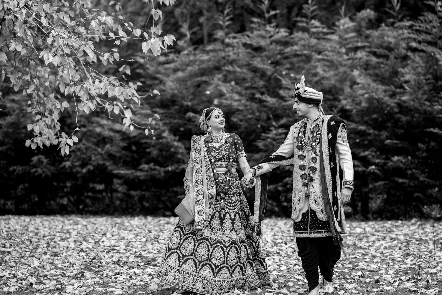 Black and white outdoor wedding photography session in a natural garden setting.