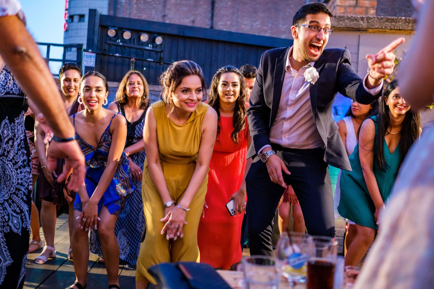 Wedding reception dance party with guests celebrating on dance floor.