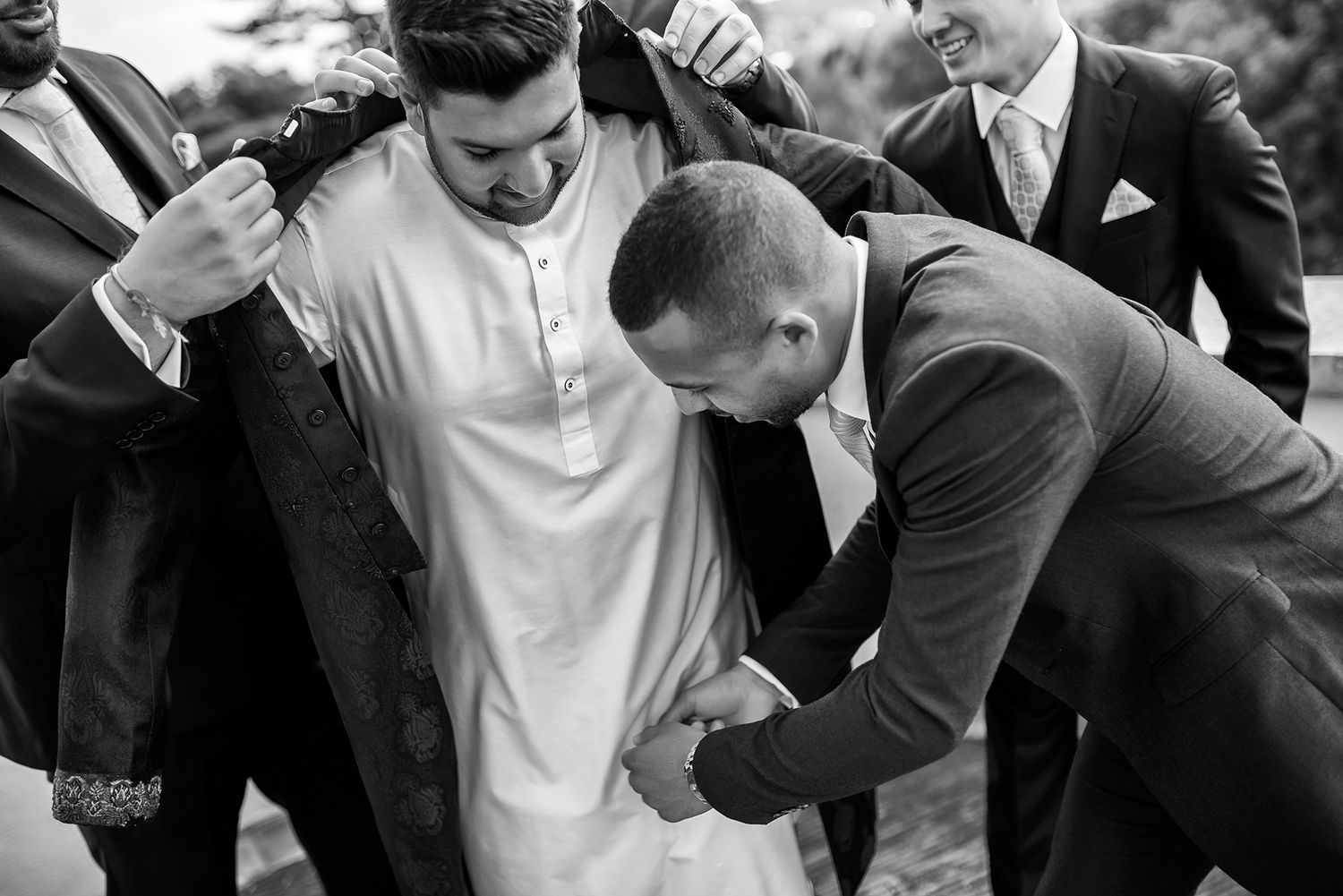 Fun groomsmen photo series showing playful interactions in formal attire.