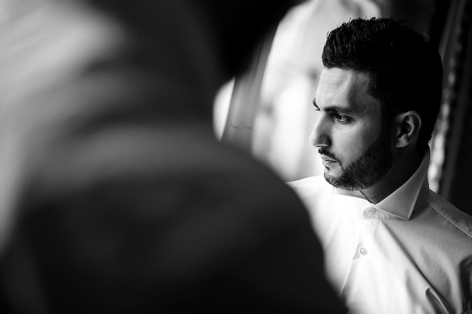 Black and white profile portrait showcasing dramatic lighting and contrast.