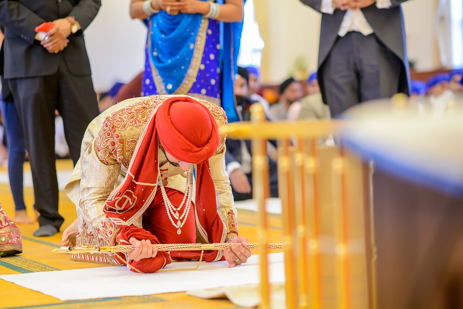 Traditional Indian wedding ceremony with detailed red and gold attire.