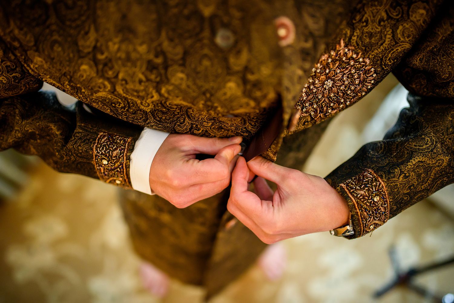 Intricate gold embroidery details on traditional Indian wedding attire.