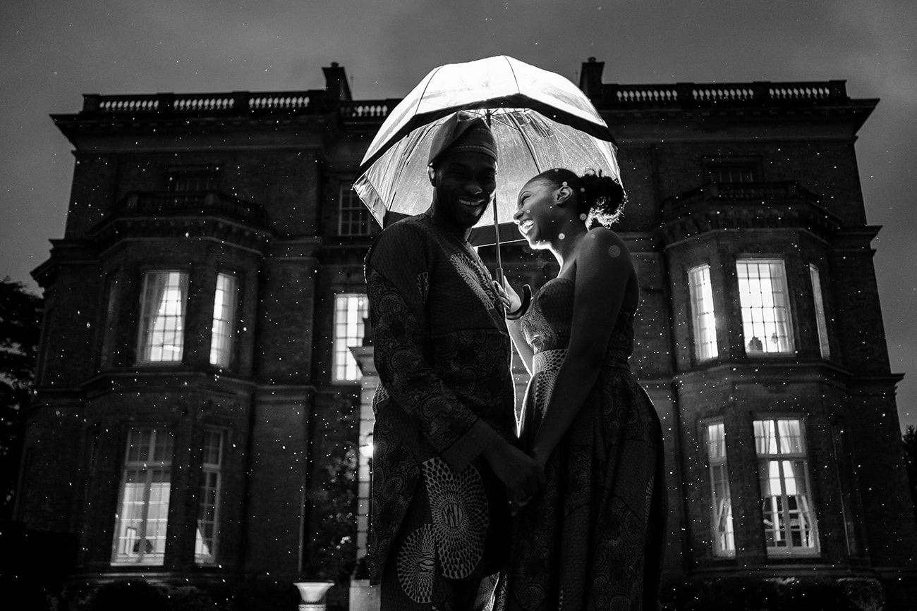 Grand historic building photographed at dusk with dramatic lighting and silhouettes.