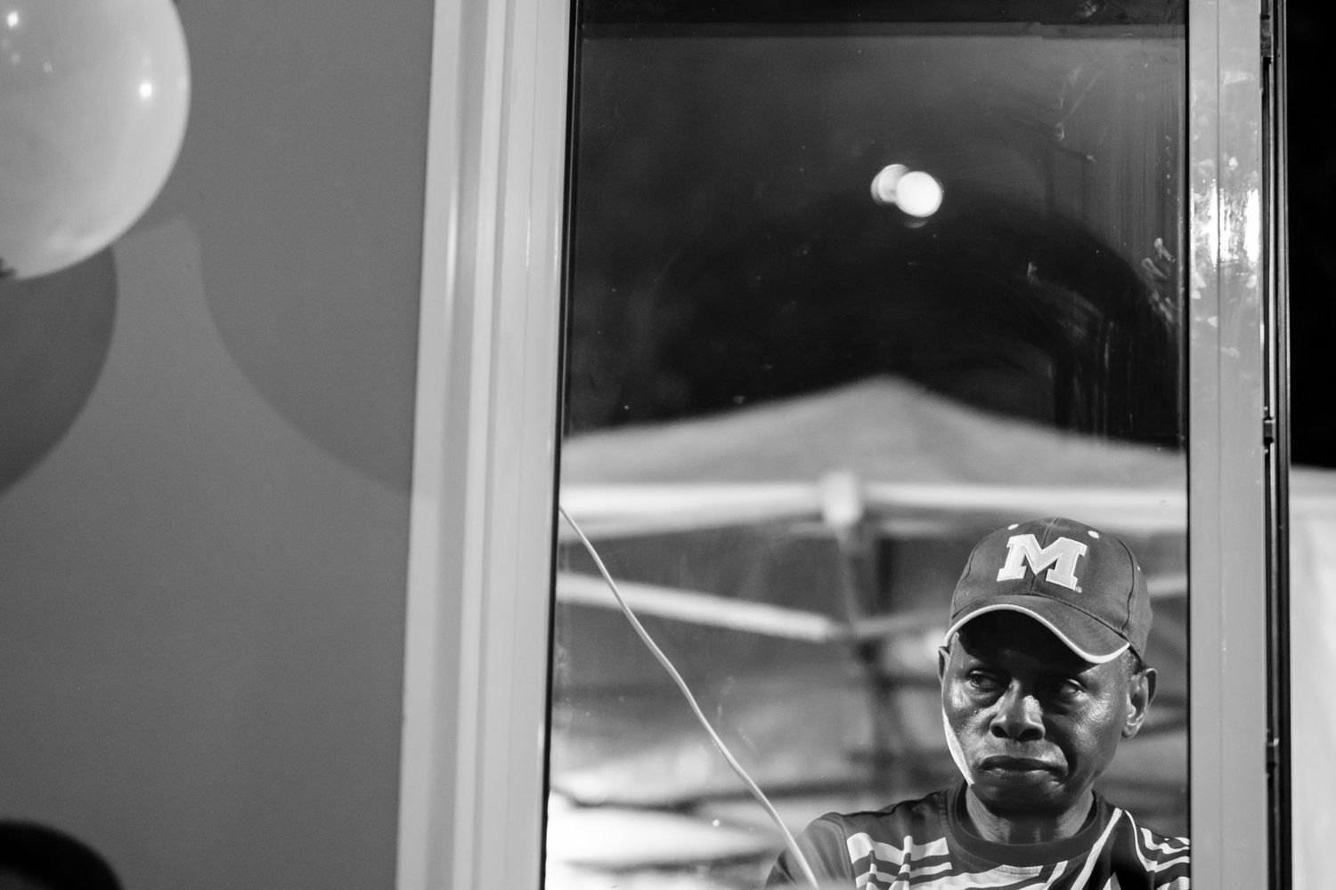 Wedding party members pose together at an evening reception.