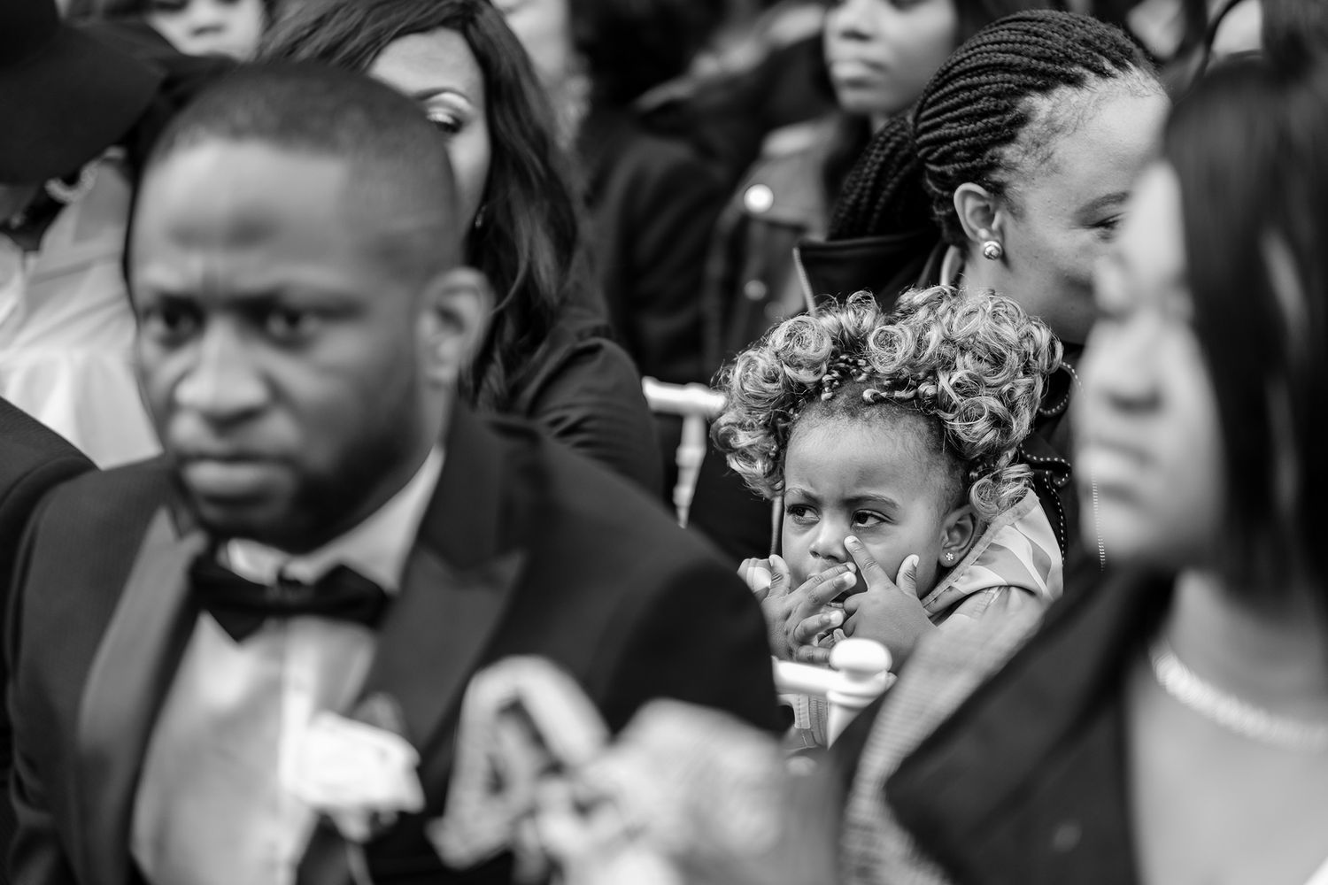 Wedding guests expressing emotional reactions during ceremony moments.