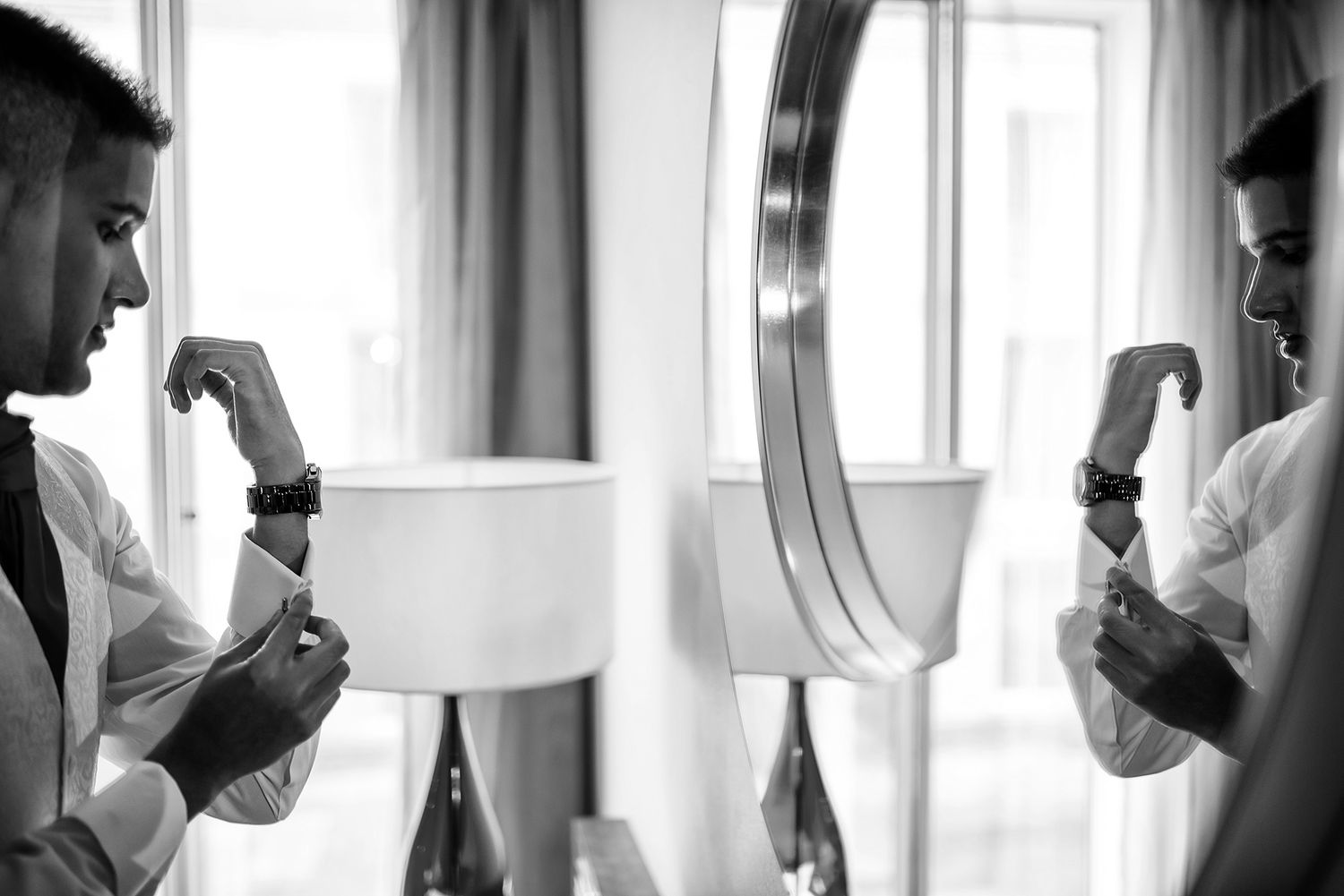 Black and white candid getting ready shots through window reflection.