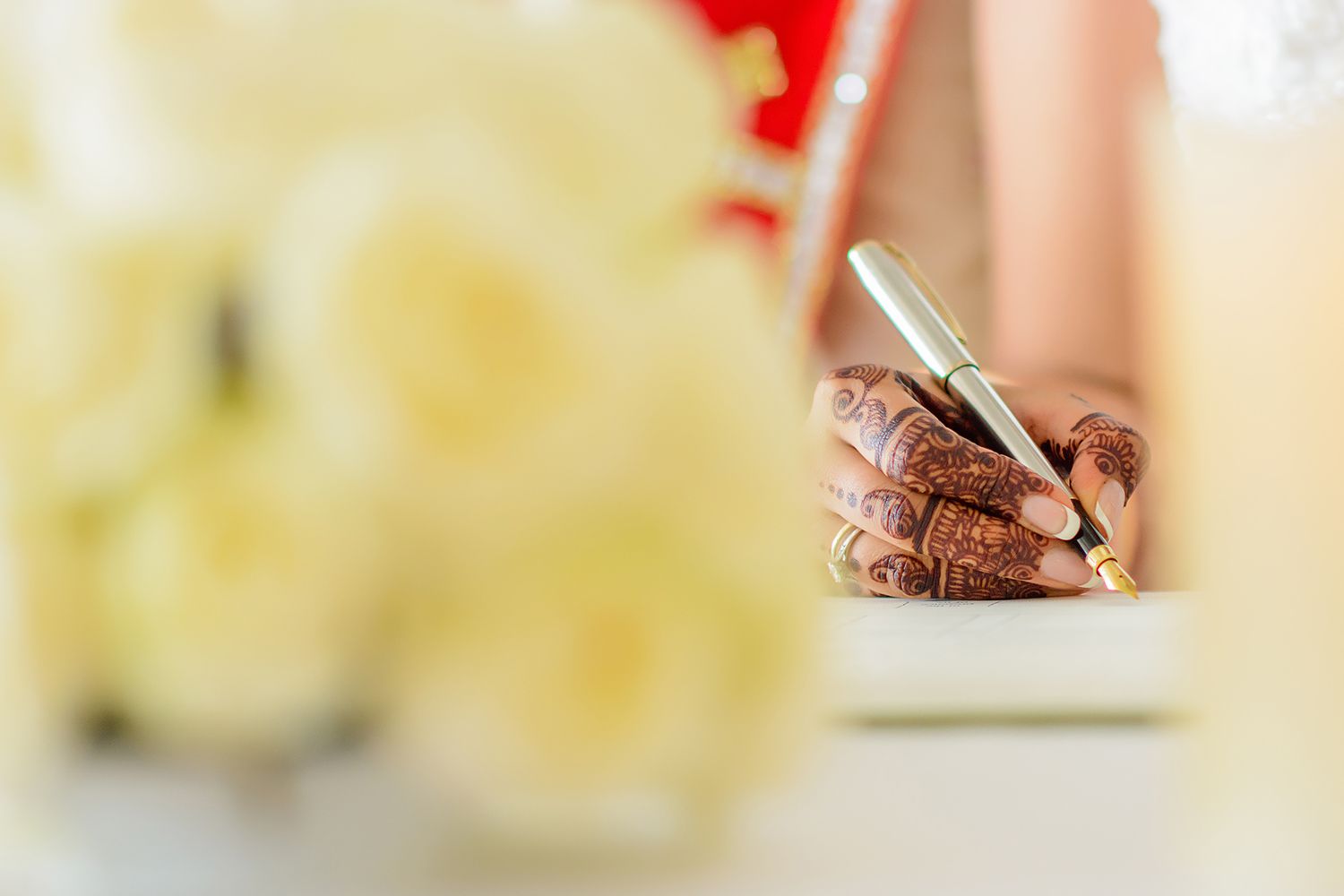 Elegant wedding detail shot with soft focus on floral arrangements and decorative elements.