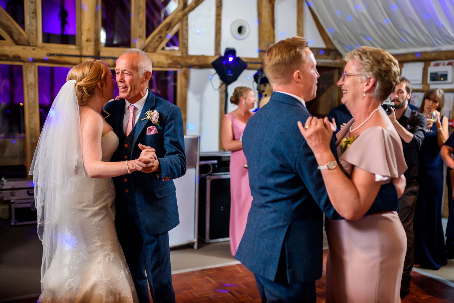 Wedding celebration in a rustic venue with mood lighting.