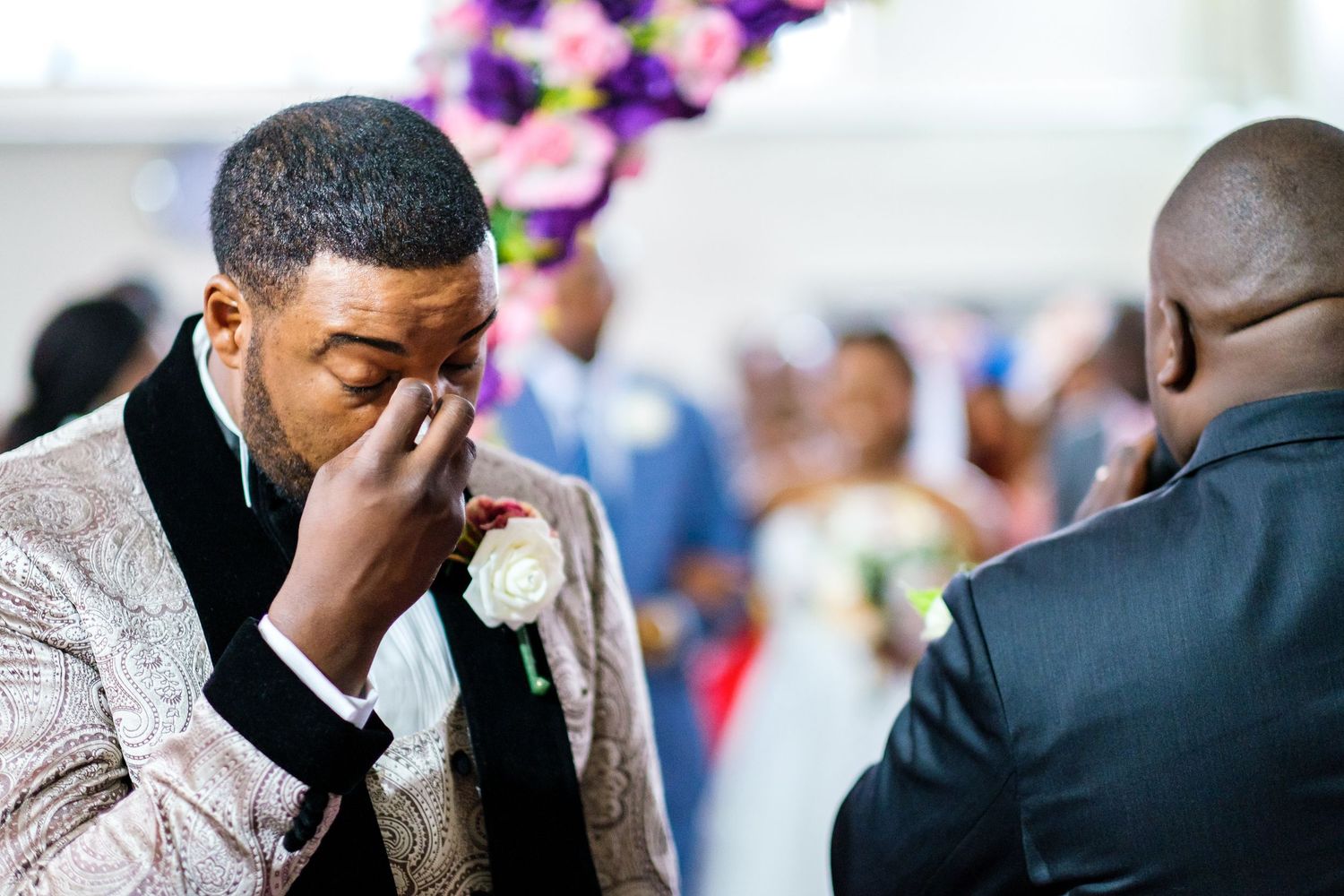 Wedding guests celebrating with emotional expressions during ceremony.