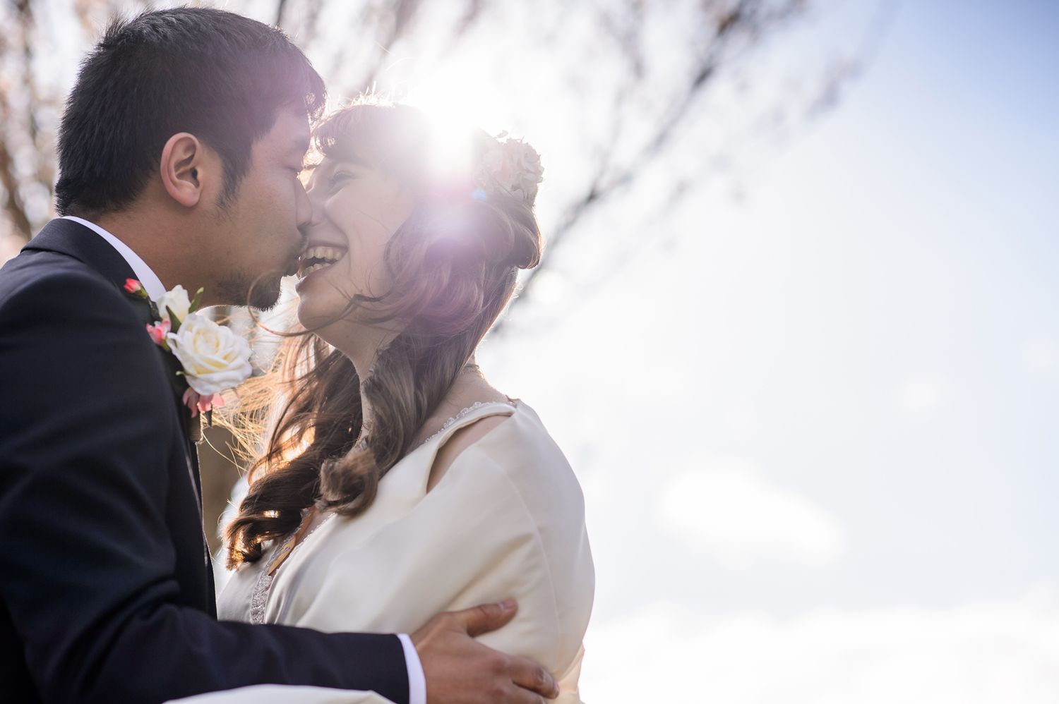 Romantic wedding couple shares intimate moments in sunlit outdoor settings.