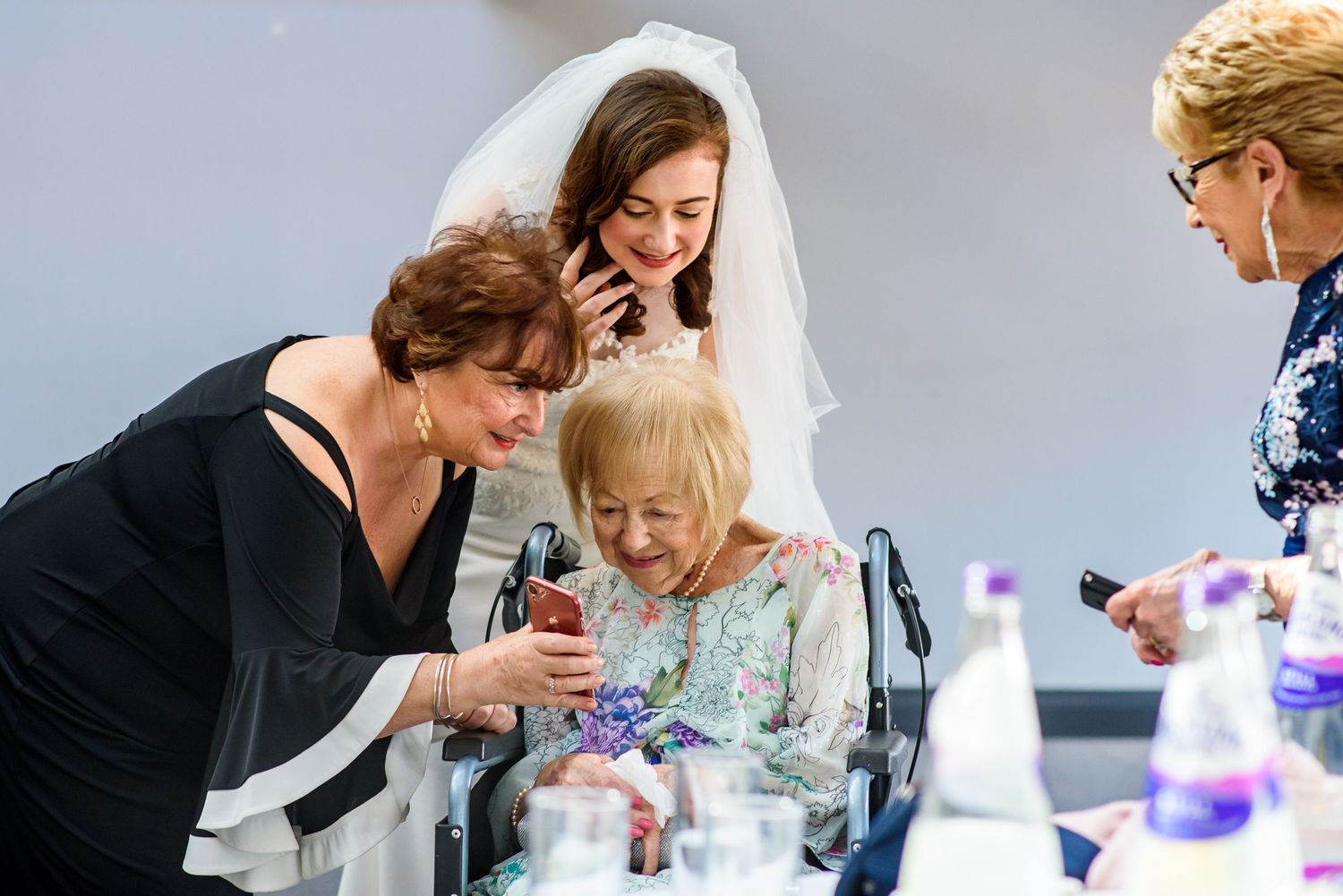 Tender moments shared between couples during a wedding celebration with purple decor elements.