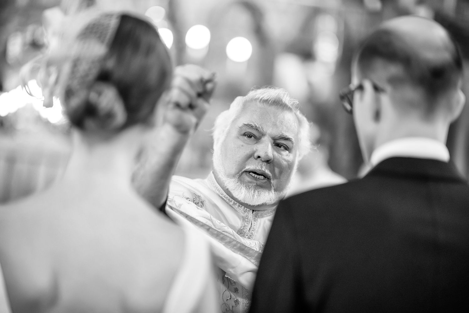 Black and white candid shots of wedding guests sharing emotional moments.
