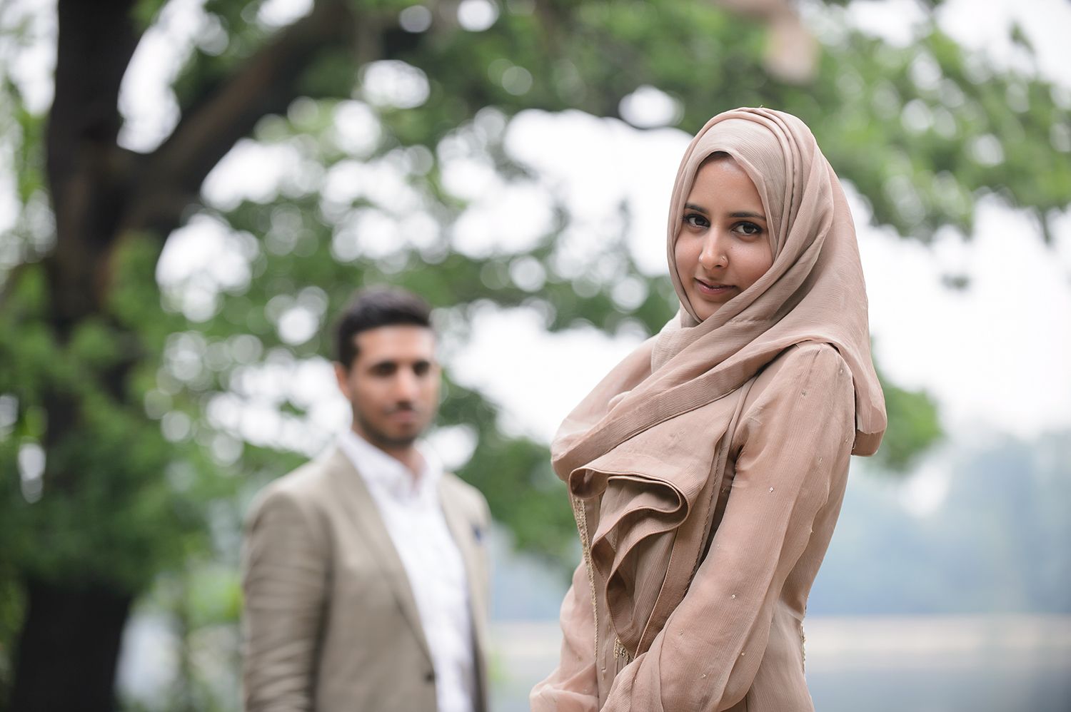 Elegant outdoor portrait session in a natural setting with trees.