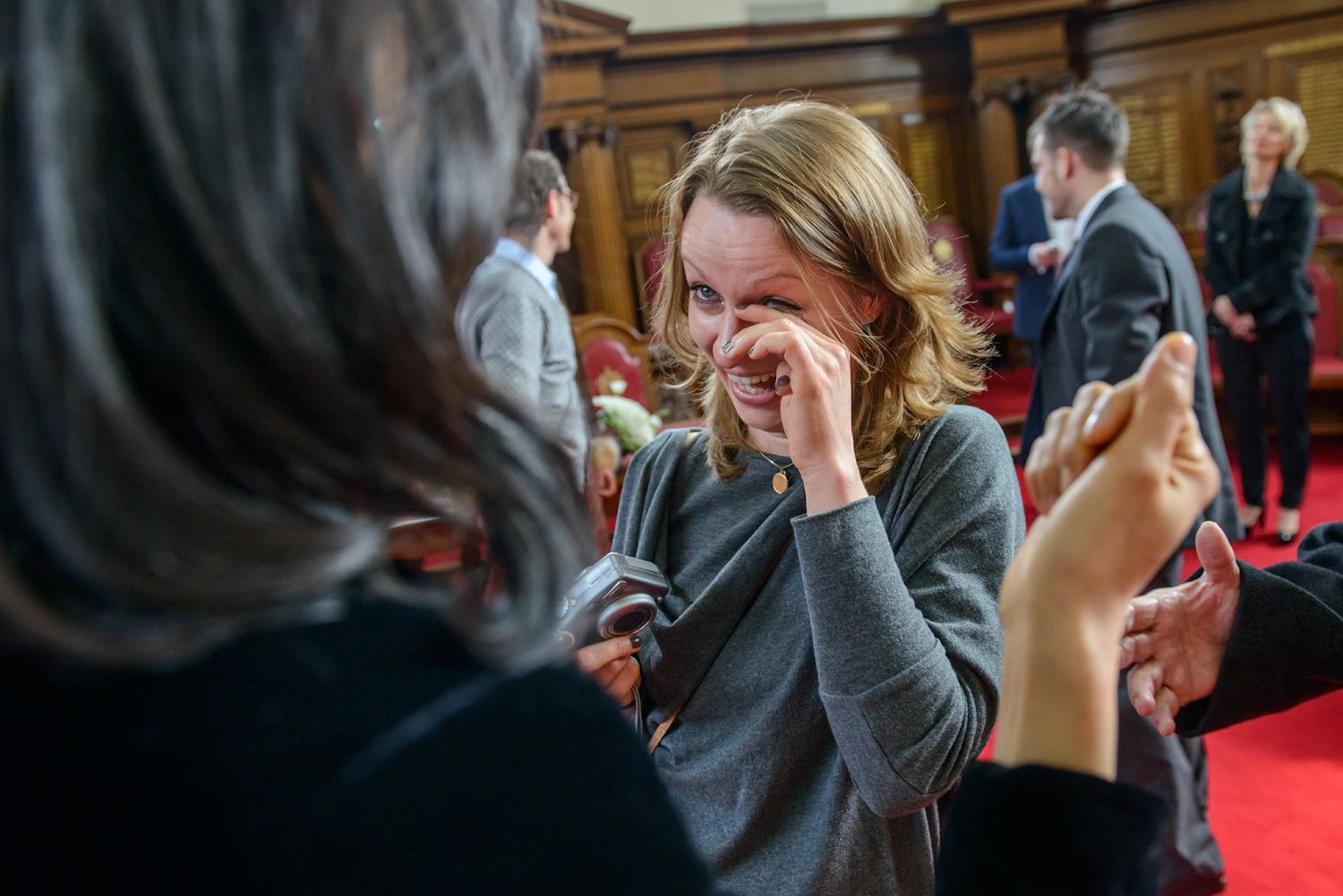 Emotional candid moments captured during an indoor wedding ceremony.