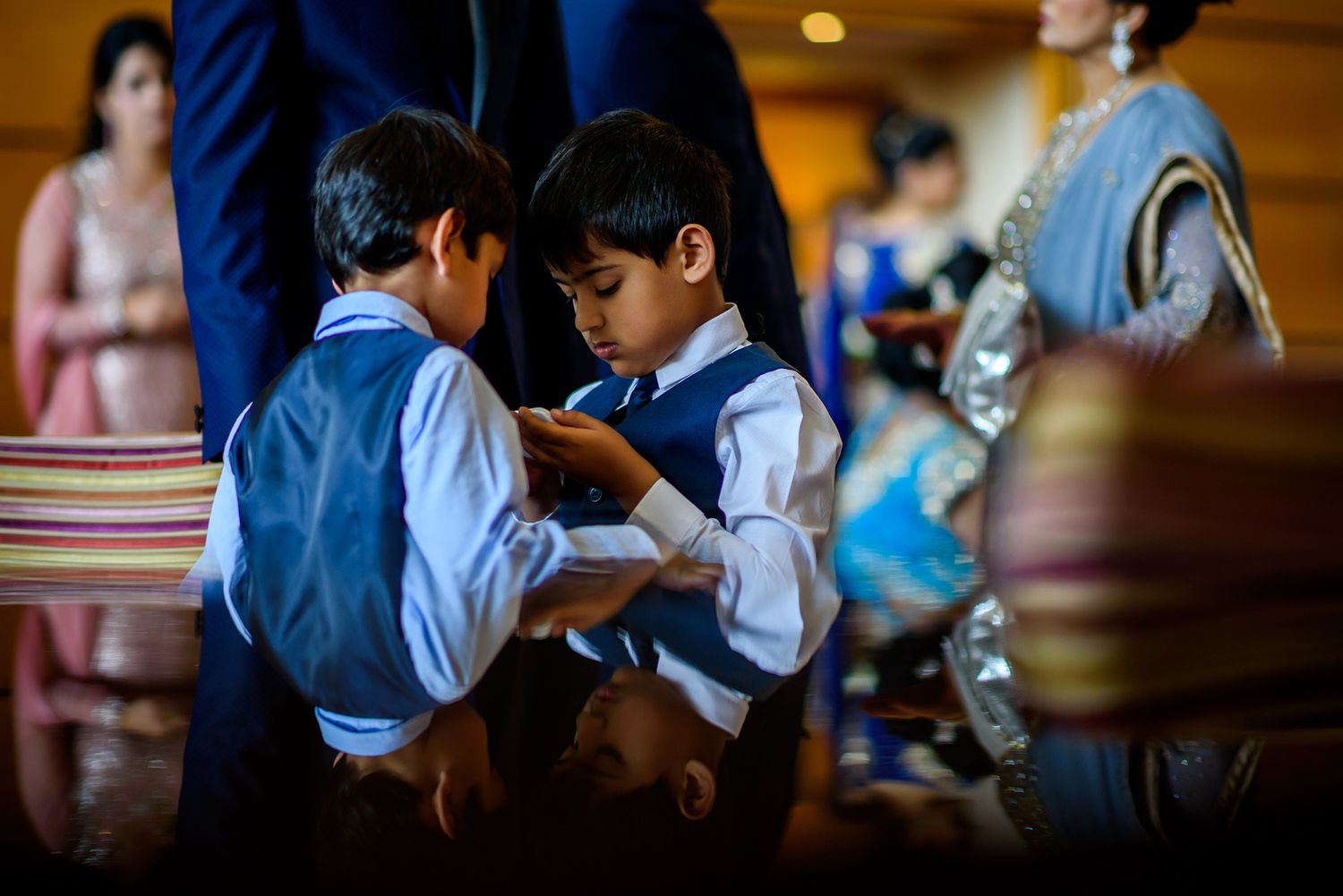 Guests interact during an elegant indoor wedding celebration with warm lighting.