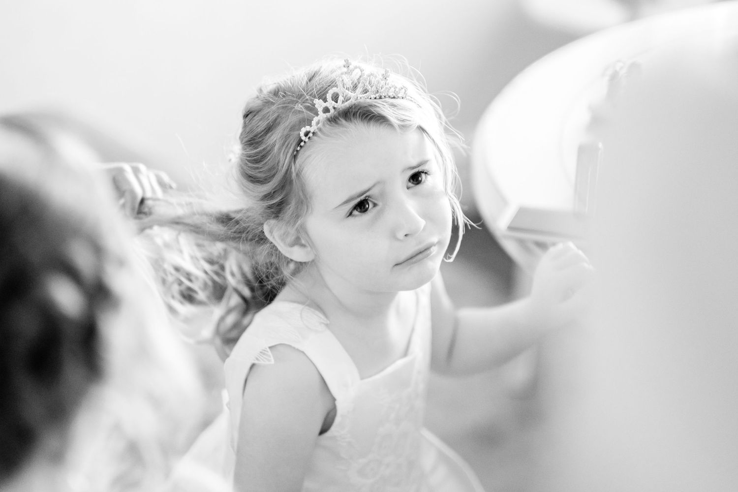 A series of black and white wedding preparation photos showing elegant bridal styling moments.