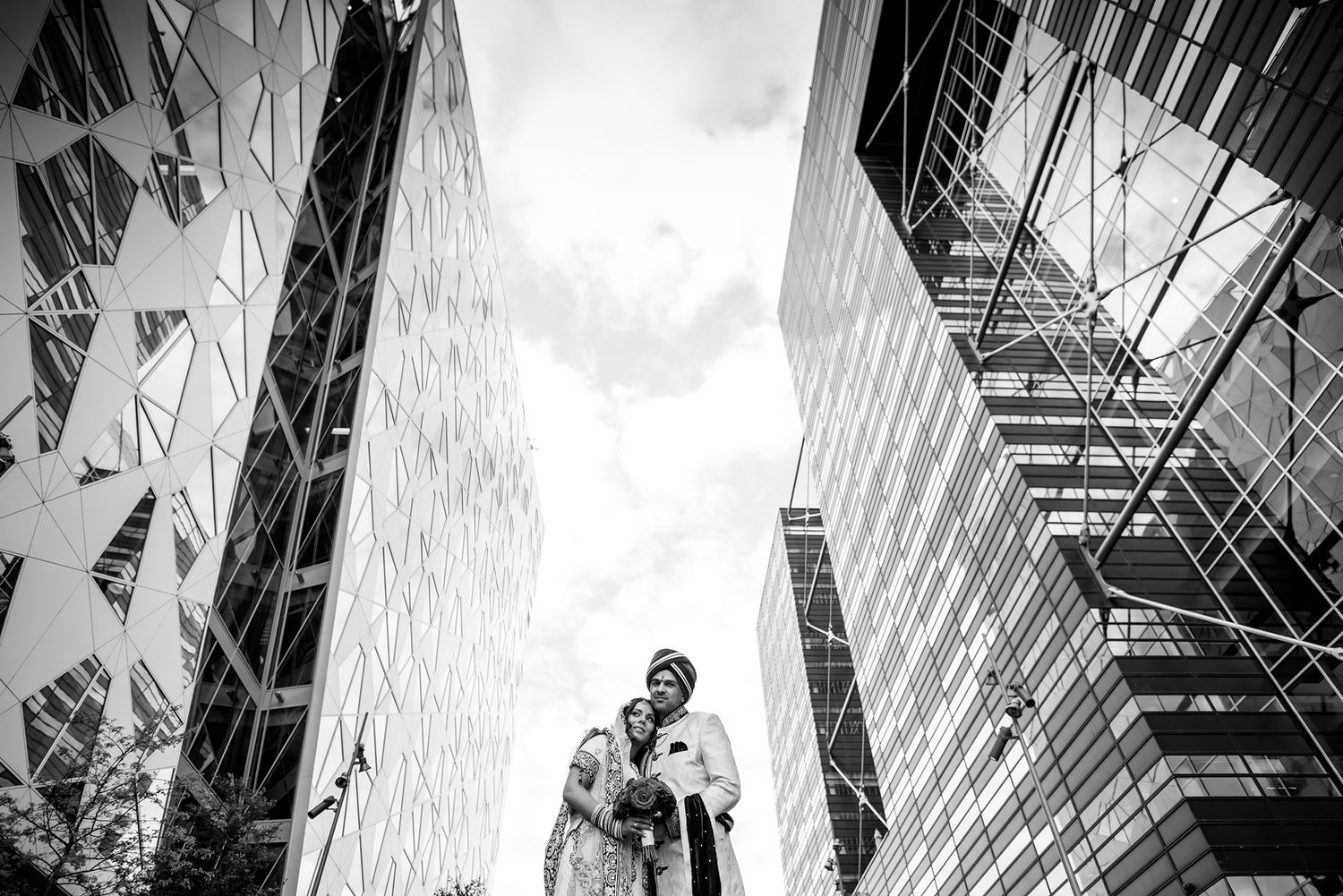 Dramatic black and white architectural shot of modern glass skyscrapers from below.