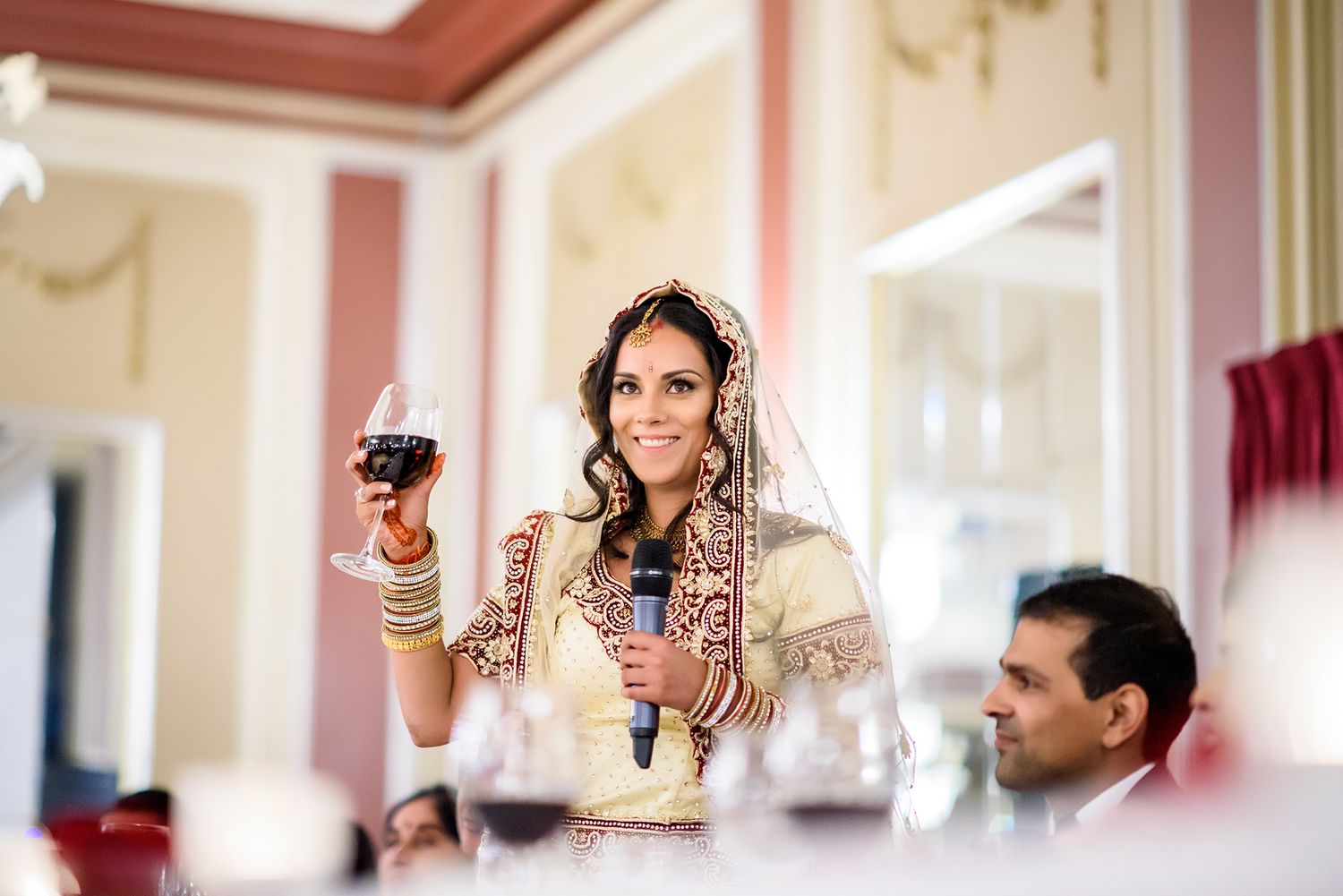 Elegant reception venue with warm lighting and traditional decor for wedding celebration.