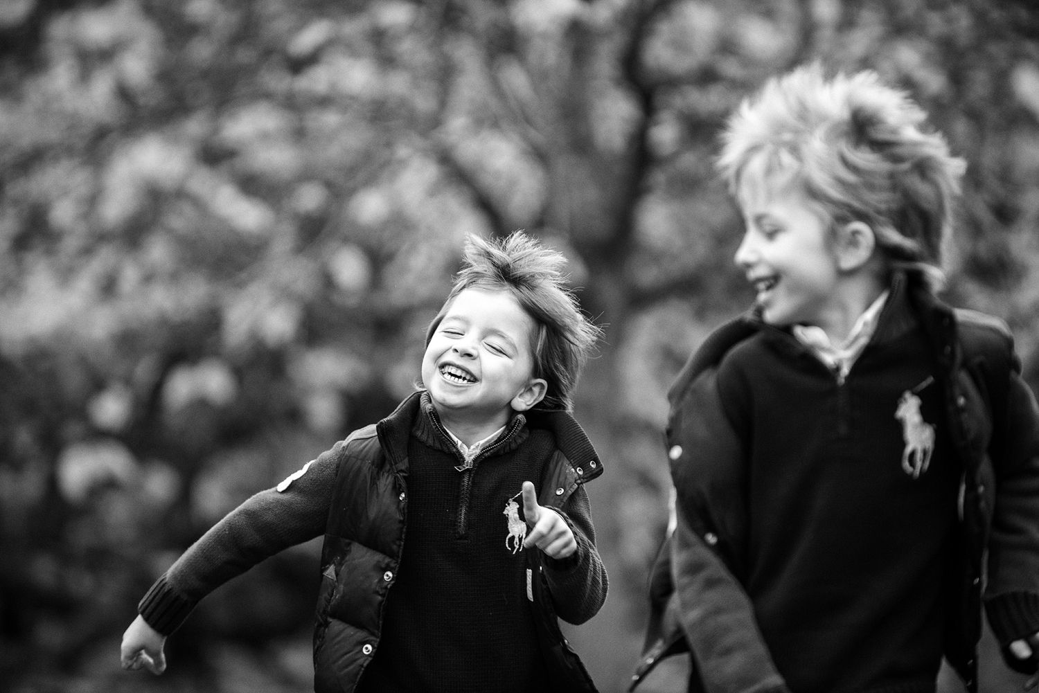 Black and white images of children playing and laughing outdoors.