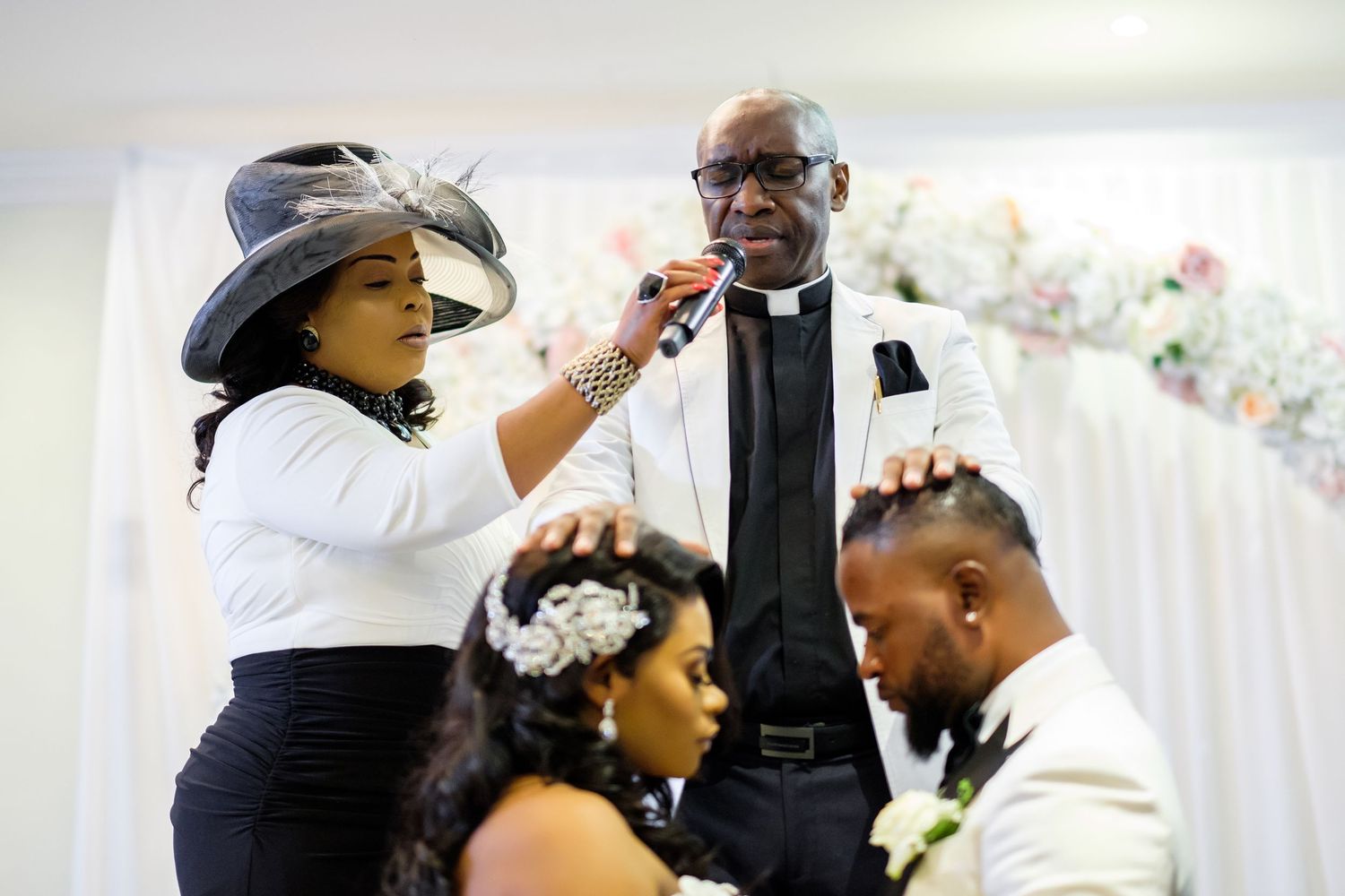 Wedding reception guests in formal attire share emotional moments during celebration.