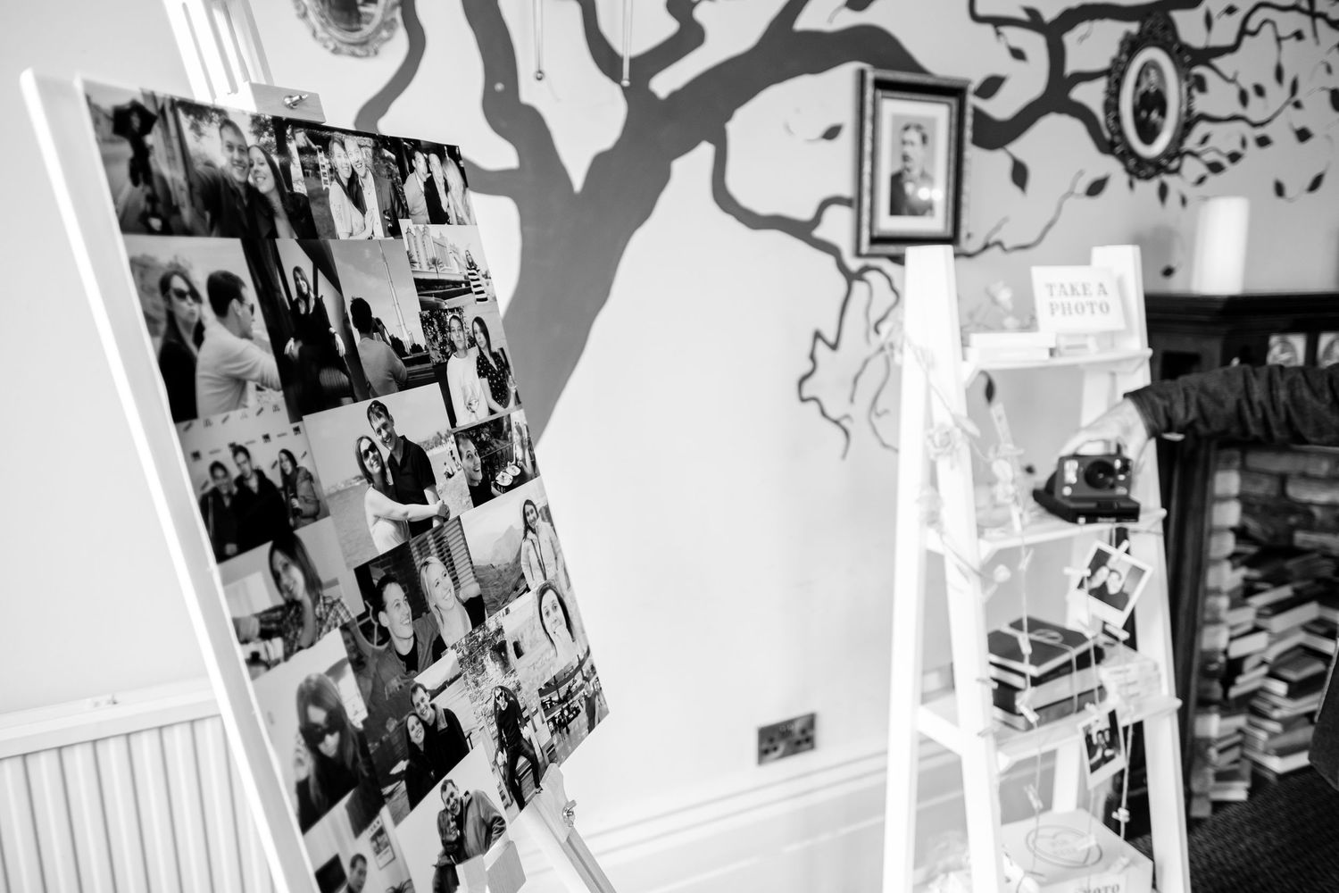 Black and white artistic wall display featuring various framed photographs.