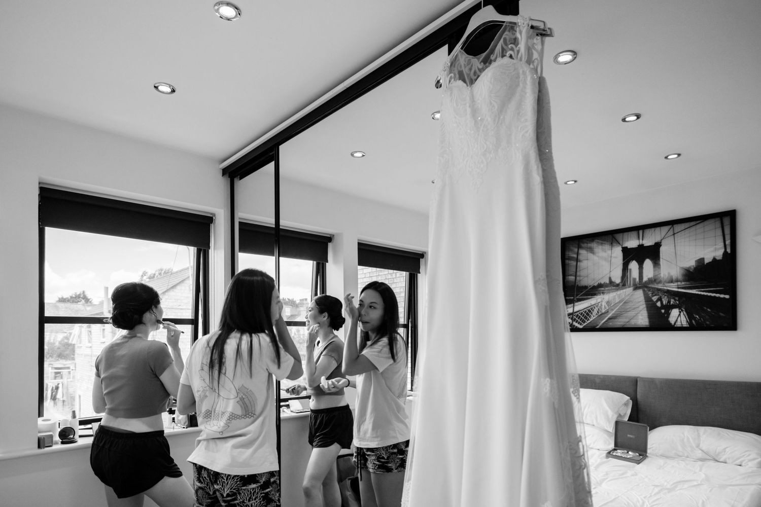Black and white wedding preparation photos showing getting ready moments in an elegant indoor setting.