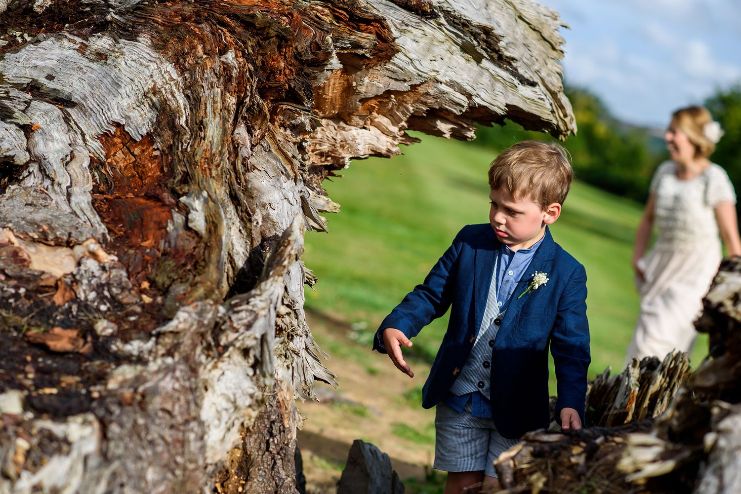 Rustic wedding photo session by textured tree bark outdoors.