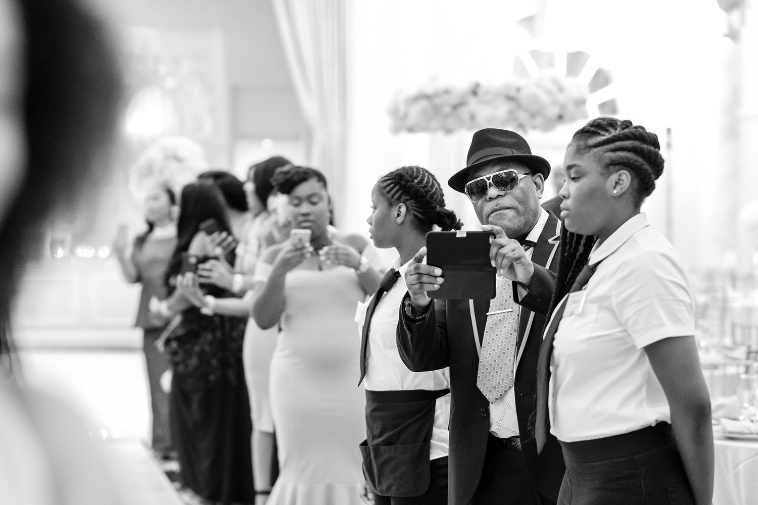 Wedding guests dancing and celebrating in formal attire at the reception.