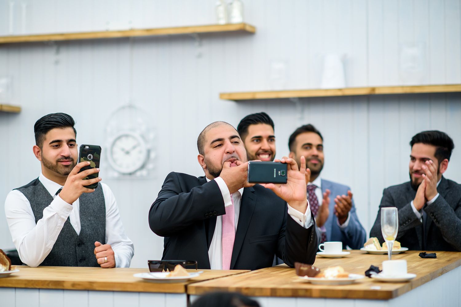 Row of guests seated at a long table during a formal event.