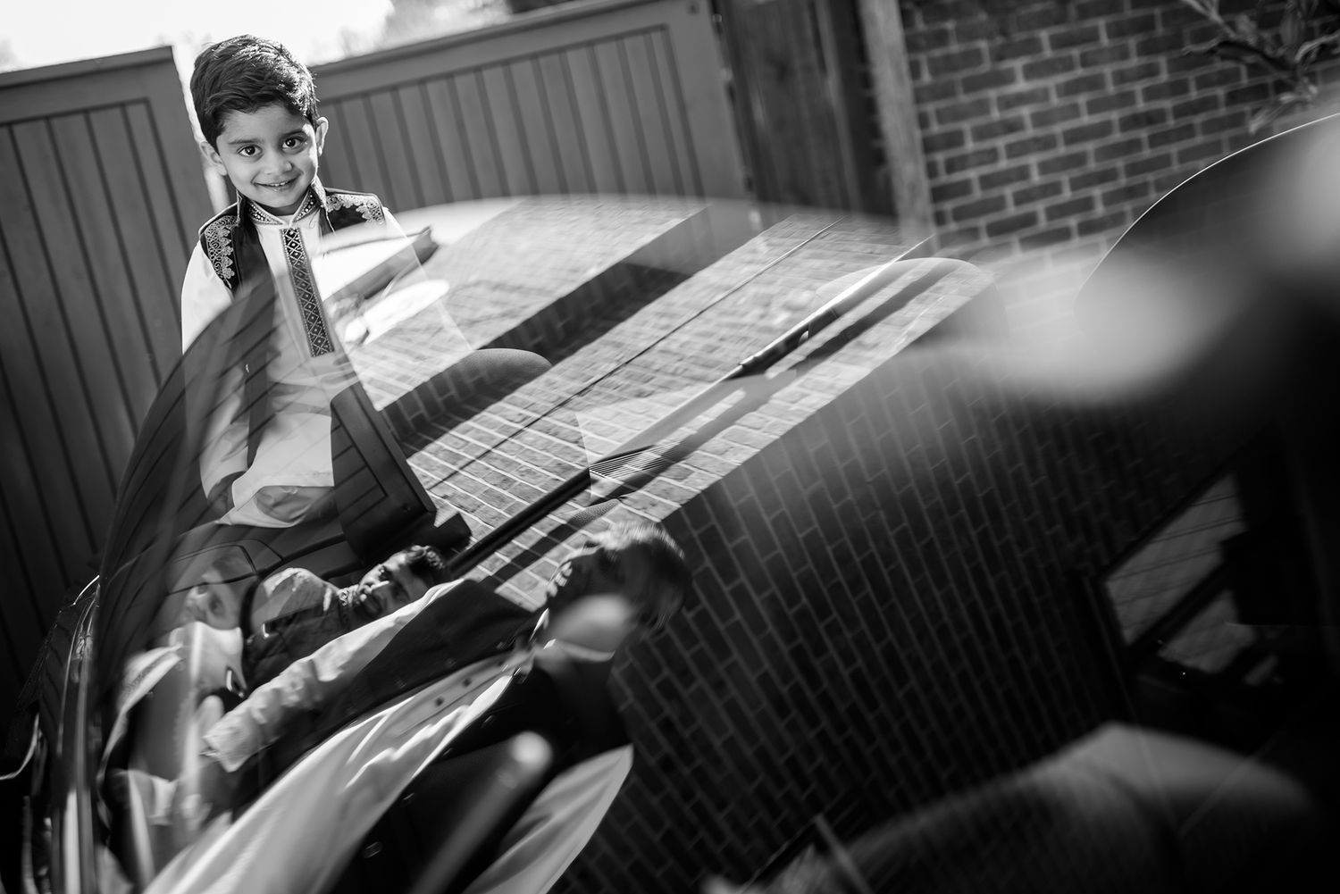 Black and white wedding ceremony photograph showing emotion and intimate moments during the celebration.