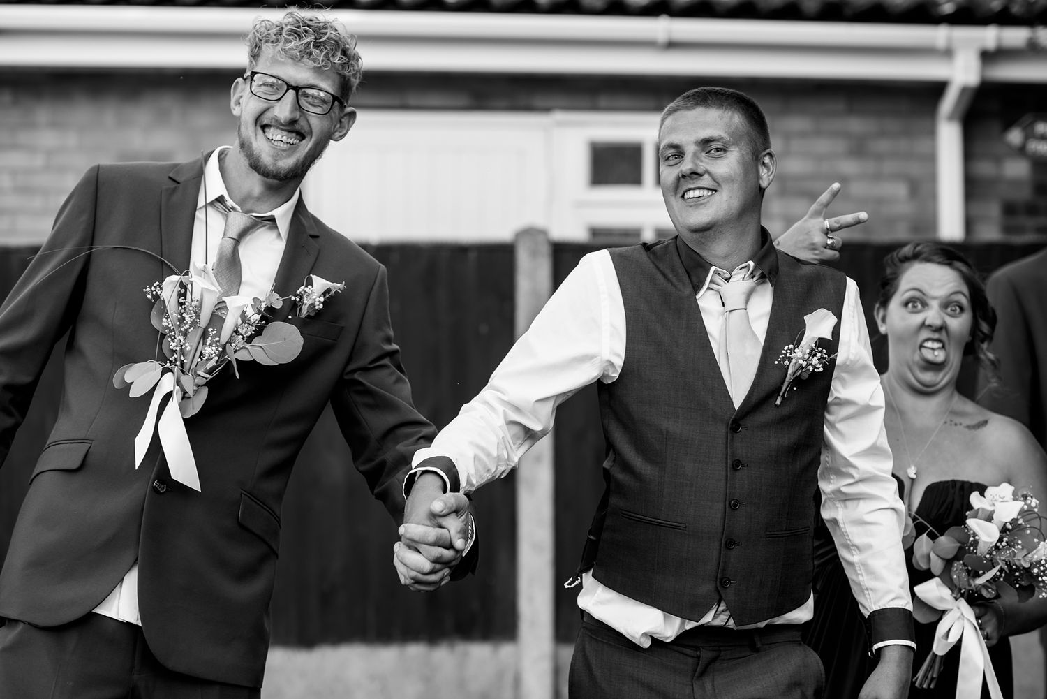 Wedding guests laugh and celebrate during outdoor reception party.