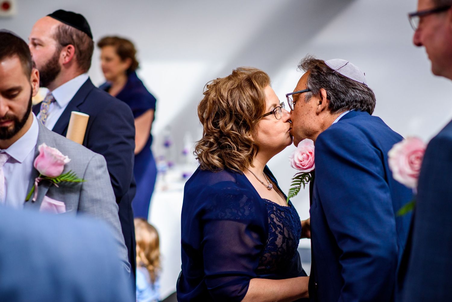 Intimate moment shared during a Jewish wedding celebration indoors.