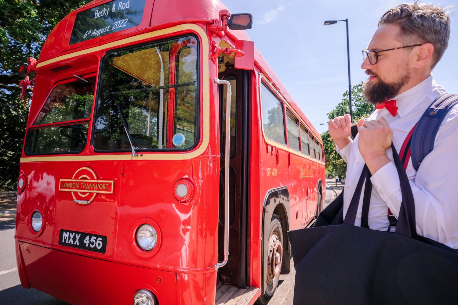 A vintage red London double decker bus parked outdoors with multiple angles showing its classic design.