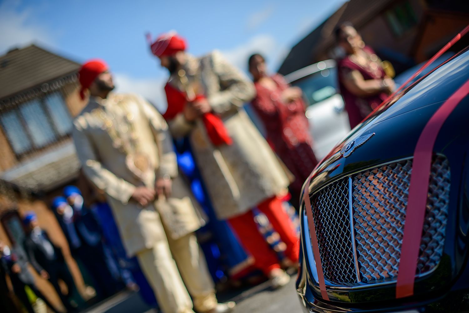 Luxury wedding cars lined up with decorative details and ribbons.