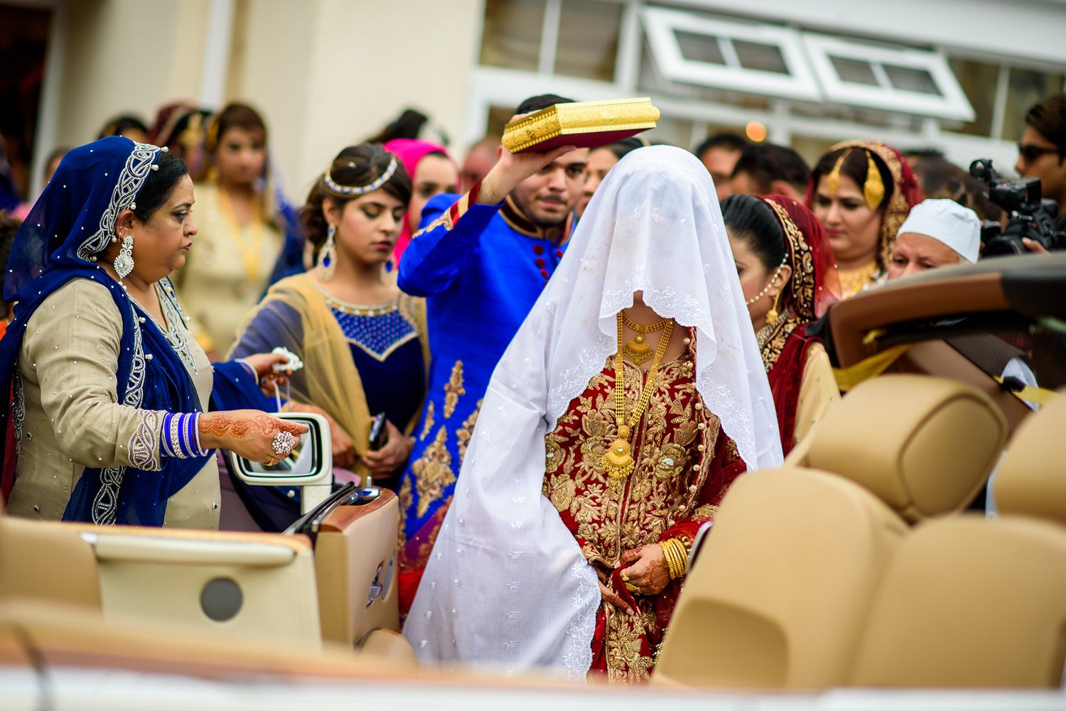 Guests gather in celebration at decorated wedding venue with traditional decor.