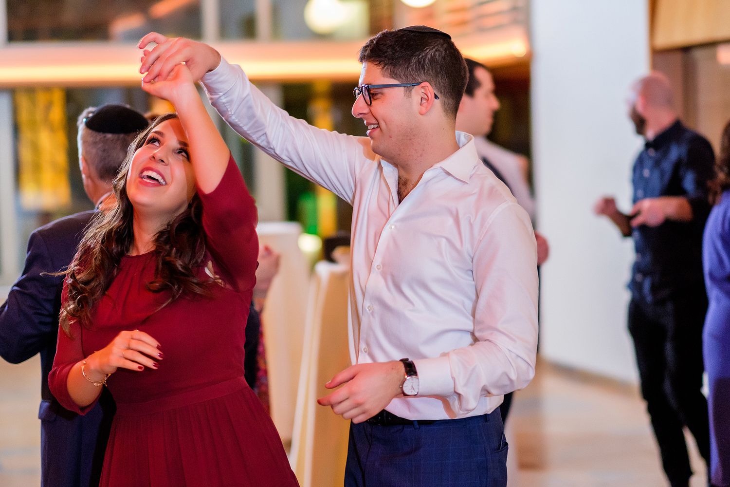 People dancing and having fun at a formal evening celebration.