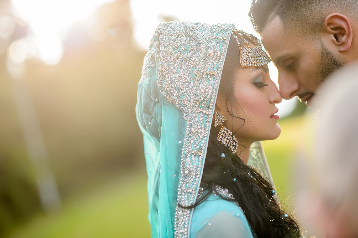 Romantic sunset portrait featuring traditional South Asian bridal attire.