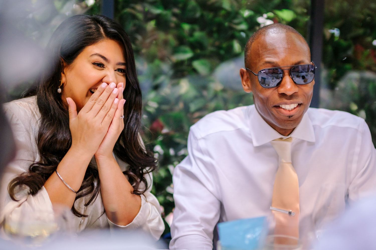 A candid moment of joy and laughter captured during a wedding celebration.