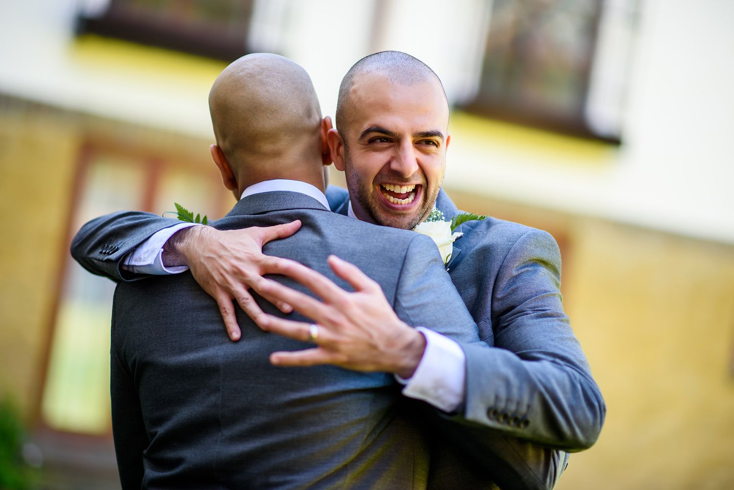 Emotional embraces and hugs between wedding guests outdoors.