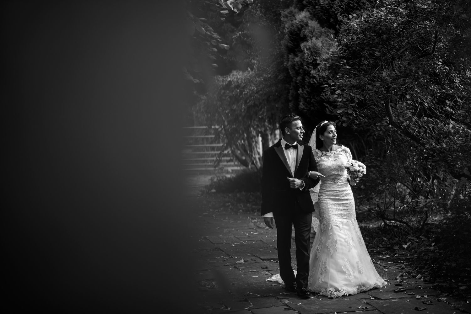 Outdoor wedding portrait with natural scenery and soft lighting.