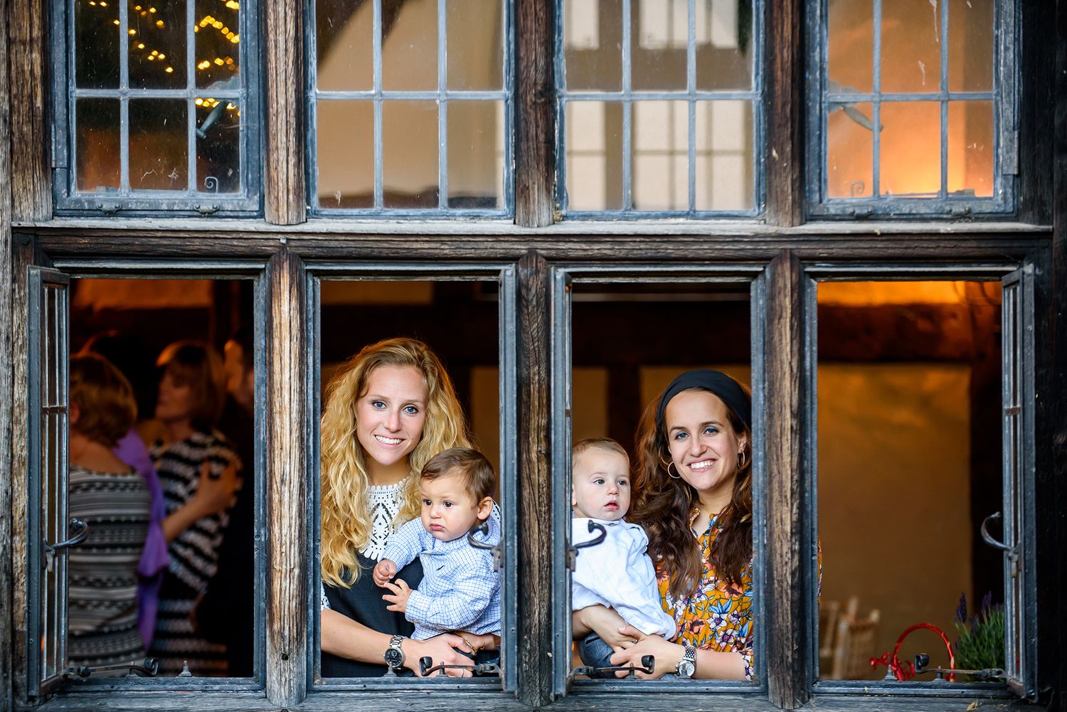Multiple window panes frame candid moments of celebration at a historic venue.