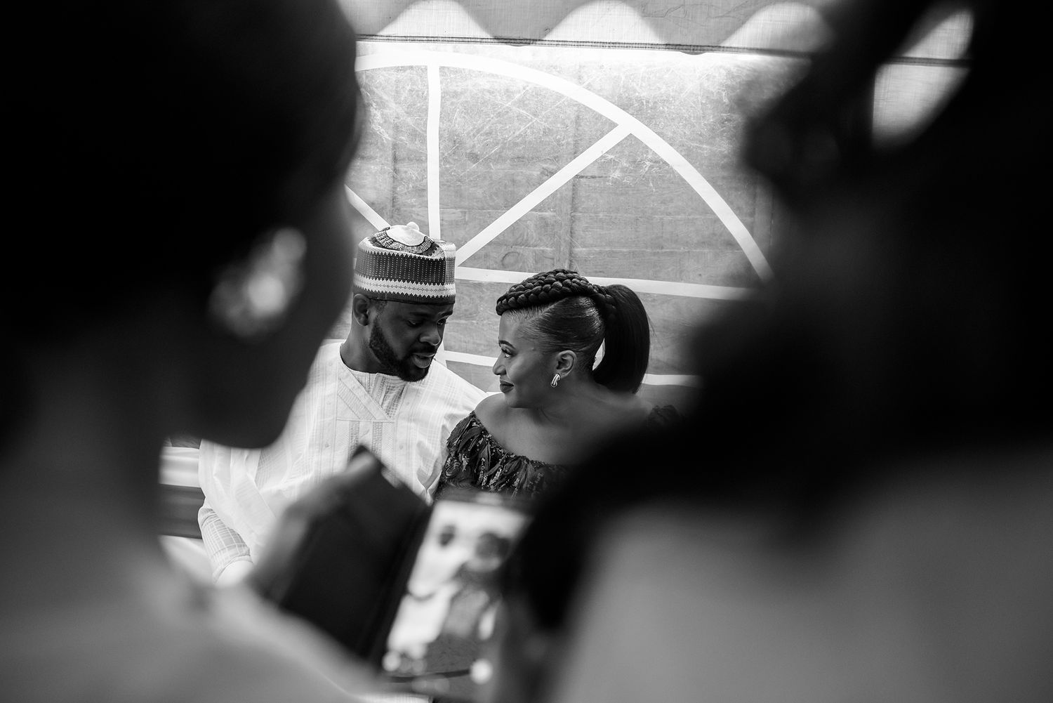 Black and white photo of people celebrating at an outdoor party under tent.