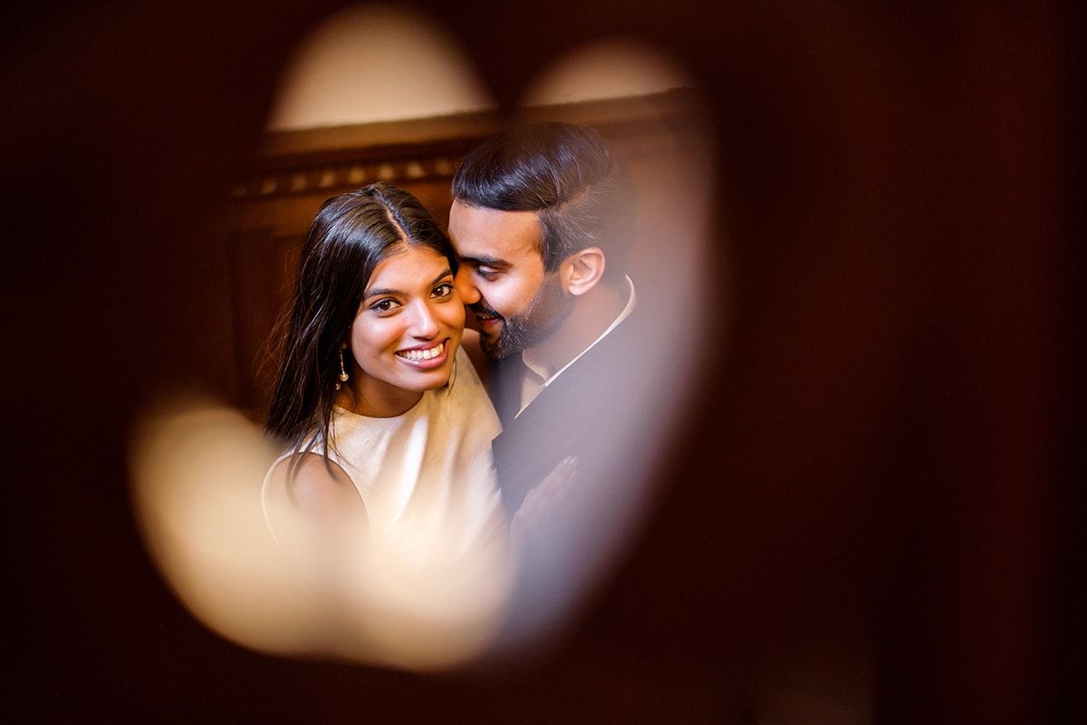 Intimate wedding portrait captured through creative blurred framing.