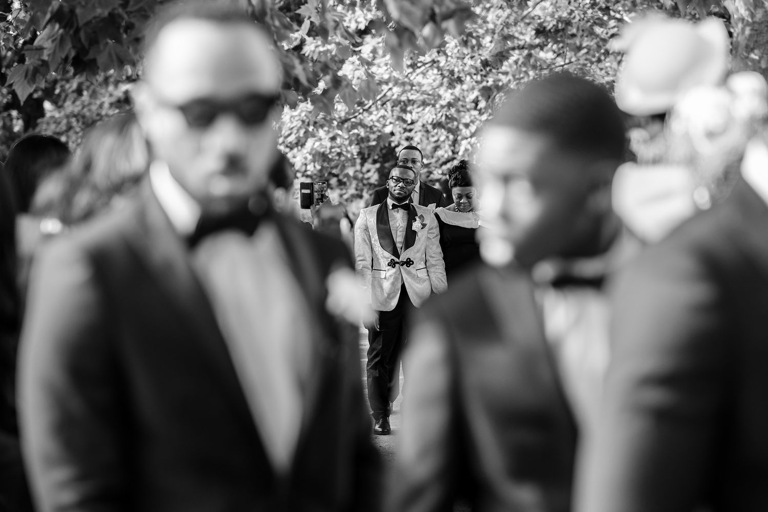 Wedding guests view emotional reactions during an outdoor ceremony.