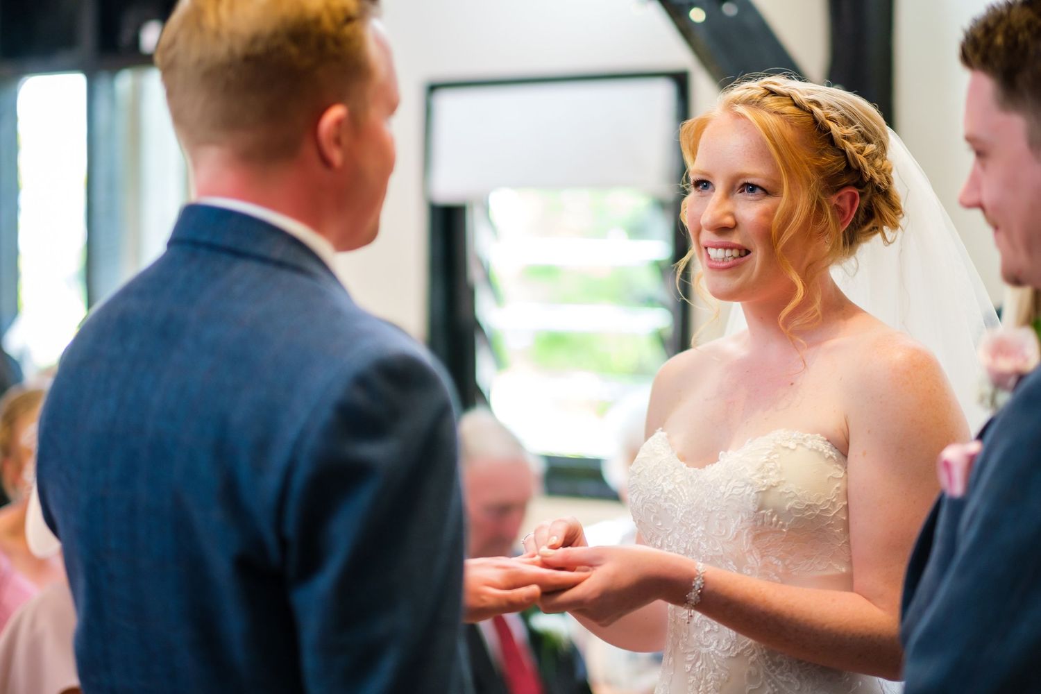 Wedding party members share joyful moments at an indoor celebration.