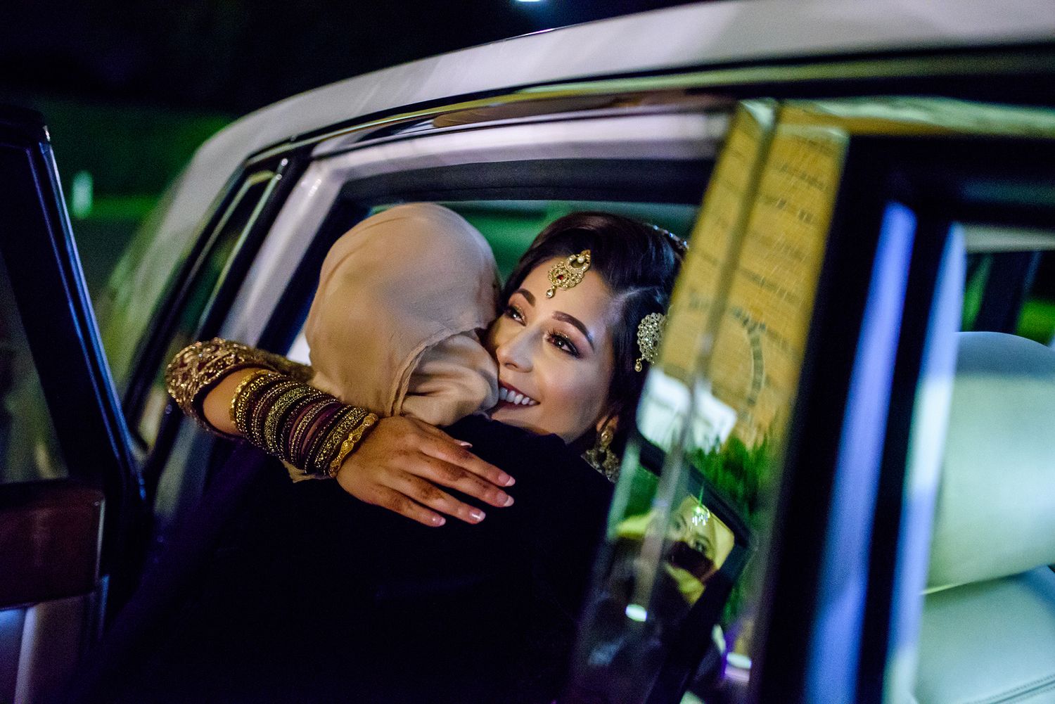 Emotional departure moment captured through a car window during a wedding celebration.