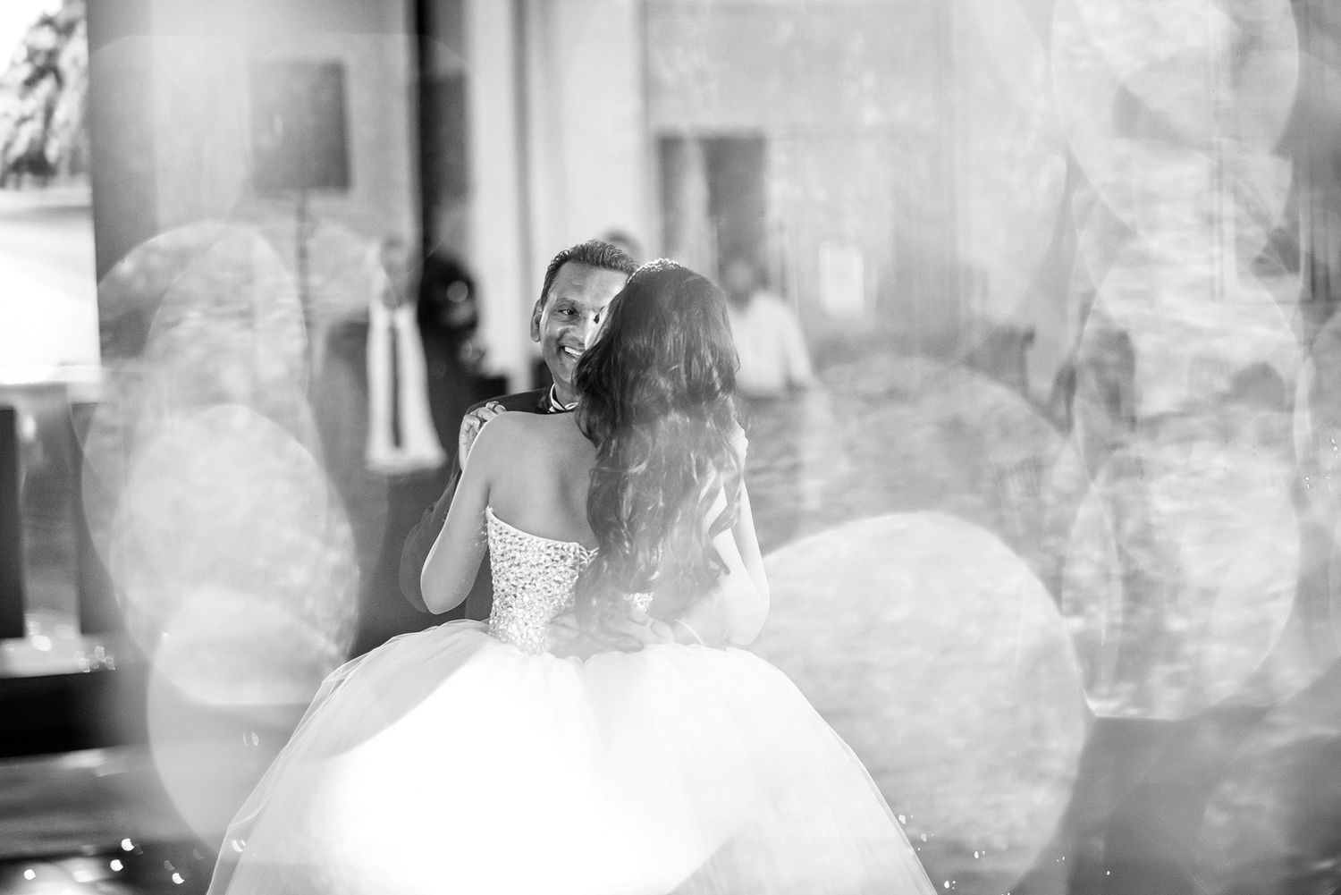 Atmospheric black and white photo capturing wedding reception celebration moments.