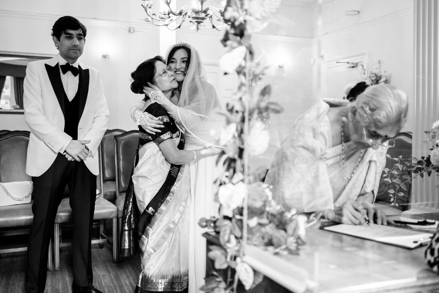 A collage of black and white wedding photographs showing intimate moments during a celebration.