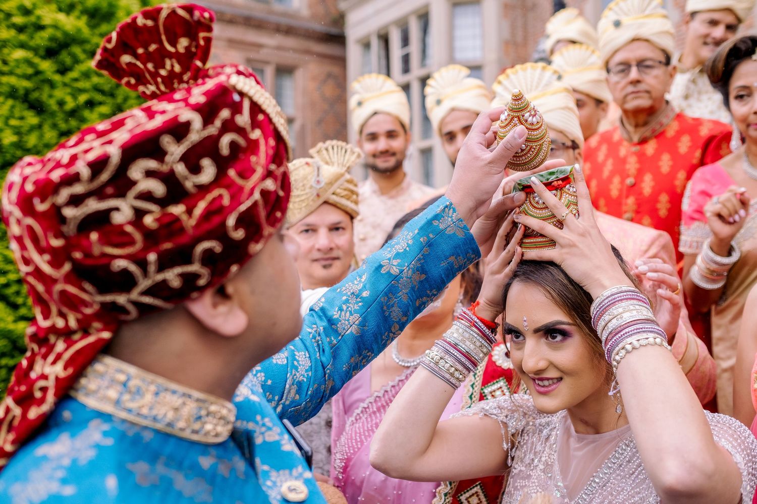 A lively outdoor celebration with people wearing colorful scarves and traditional attire.