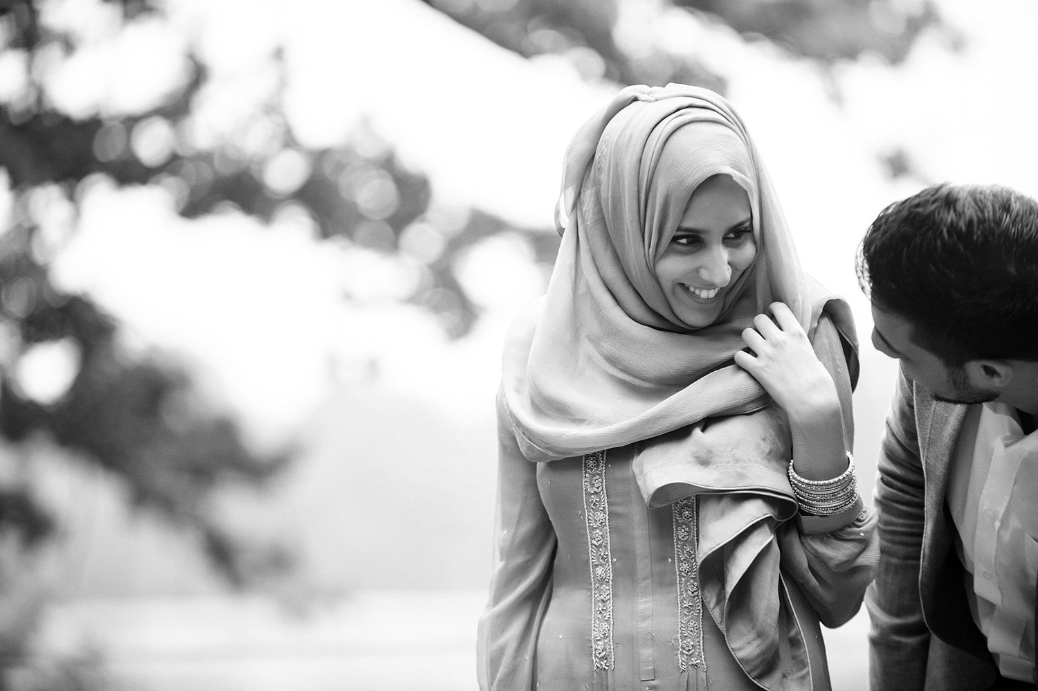 Intimate outdoor photo session with natural lighting and foliage.